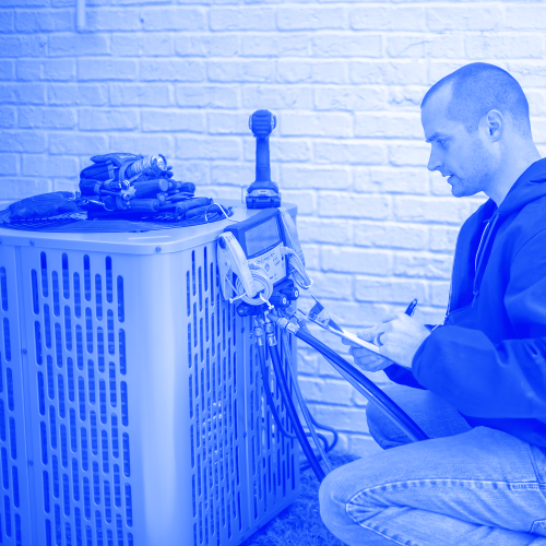 Technician performing AC repair and maintenance on exterior unit