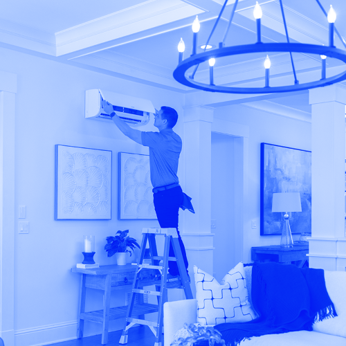 Technician installing ductless hvac unit in home