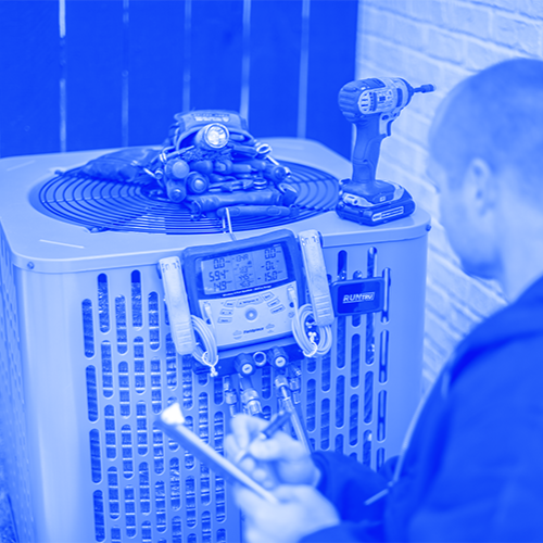Technician working on exterior AC unit